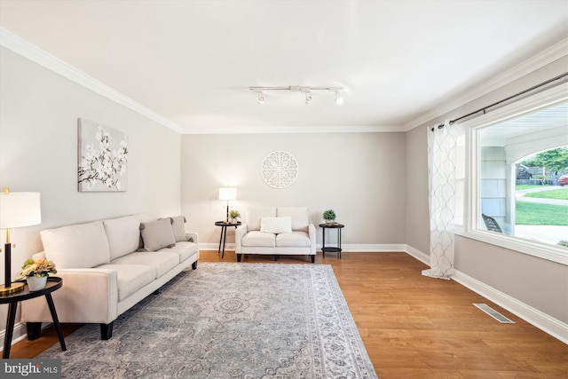 13446 Overbrook Ln, Bowie, MD 20715 - living area with wood finished floors, ornamental molding, rail lighting, and baseboards