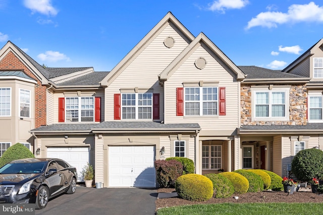 view of property with driveway and a garage