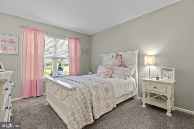 bedroom with baseboards and light carpet