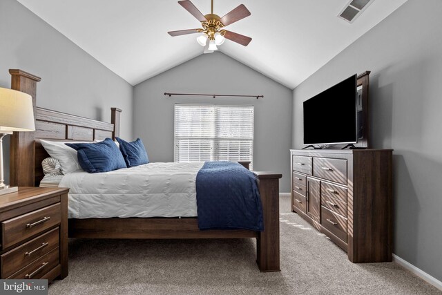 bedroom featuring a ceiling fan, visible vents, vaulted ceiling, baseboards, and light carpet