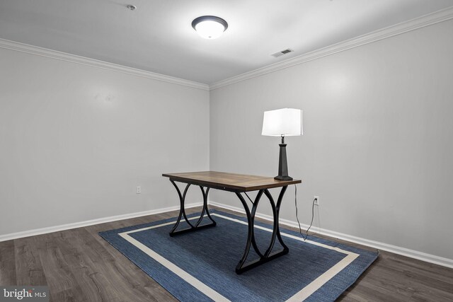 office space with visible vents, ornamental molding, baseboards, and wood finished floors