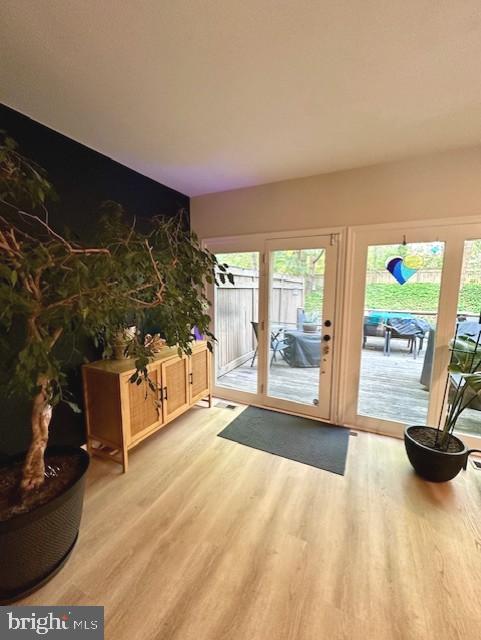 entryway with french doors and light wood-style flooring