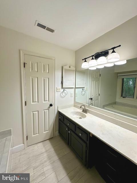bathroom with visible vents and vanity