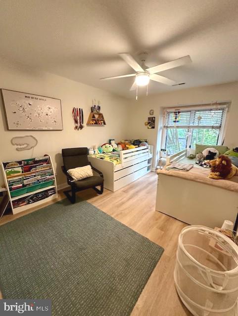 bedroom featuring ceiling fan and light wood finished floors