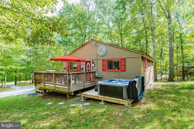 exterior space featuring a hot tub and central AC