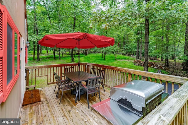 wooden deck featuring a yard and outdoor dining space
