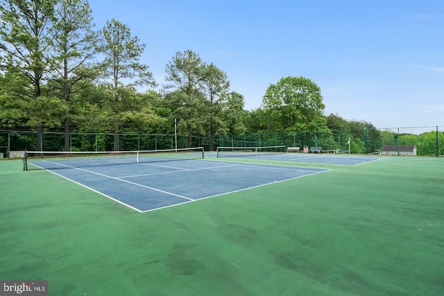 view of tennis court featuring fence