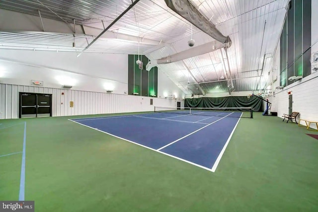 view of tennis court featuring community basketball court and fence