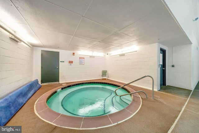 view of pool with an indoor hot tub