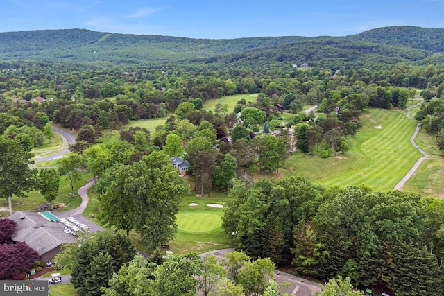 bird's eye view featuring a view of trees, a mountain view, and golf course view