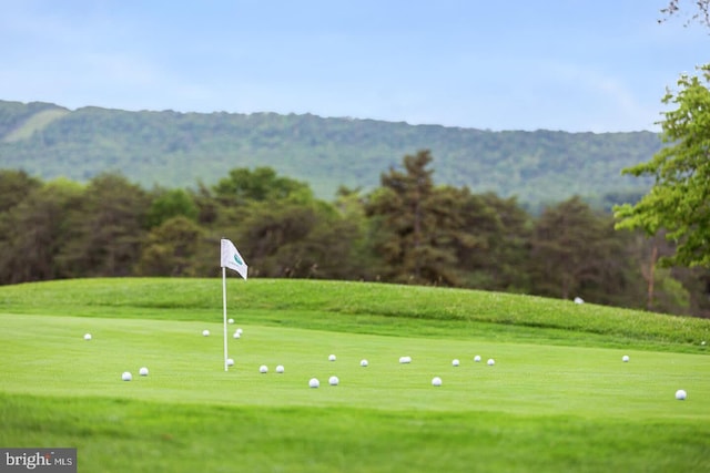 surrounding community featuring view of golf course and a mountain view
