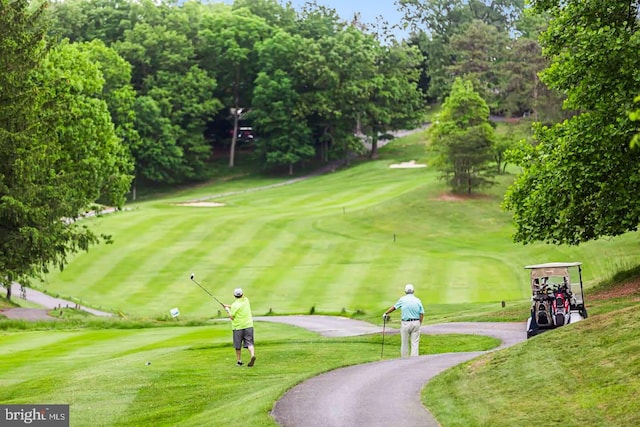 view of home's community with a lawn and golf course view
