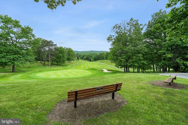 view of home's community featuring a yard and golf course view