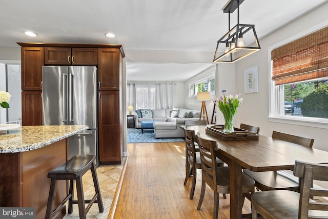 dining space featuring recessed lighting and light wood finished floors