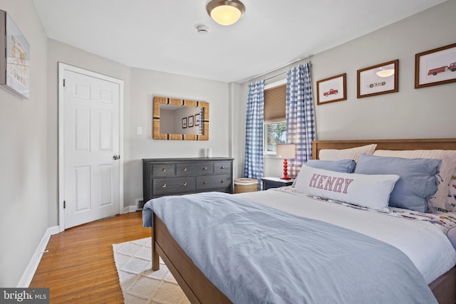 bedroom featuring baseboards and wood finished floors