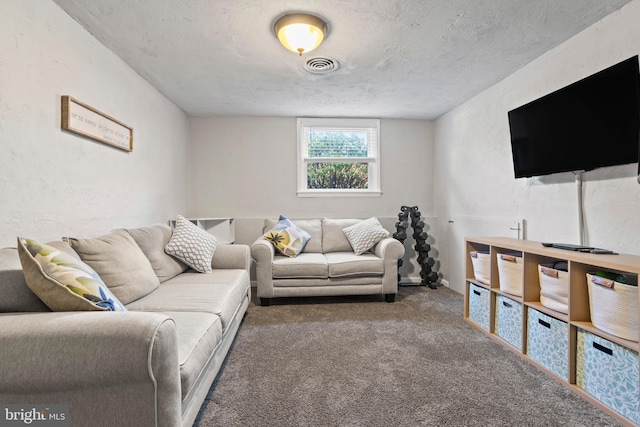 living room with visible vents, a textured ceiling, and carpet