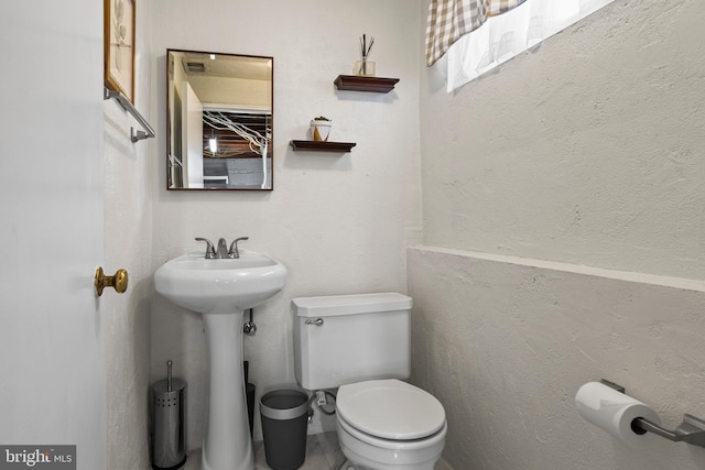 half bath featuring toilet