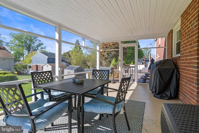 sunroom / solarium featuring outdoor dining area