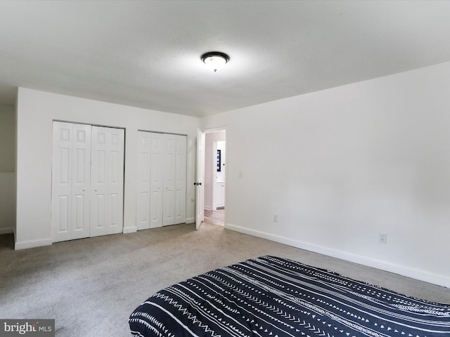 74 Red Maple Ln, Harpers Ferry, WV 25425 - unfurnished bedroom with baseboards, two closets, and carpet floors