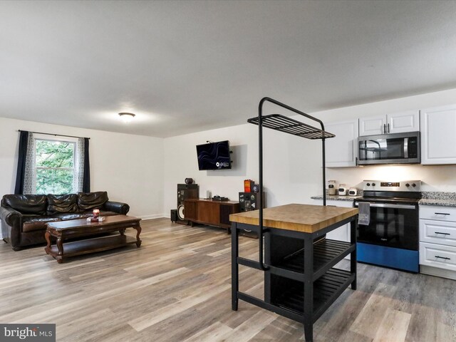 74 Red Maple Ln, Harpers Ferry, WV 25425 - kitchen featuring light wood-type flooring, white cabinetry, and appliances with stainless steel finishes