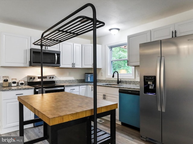 74 Red Maple Ln, Harpers Ferry, WV 25425 - kitchen featuring a sink, light wood finished floors, white cabinetry, and appliances with stainless steel finishes