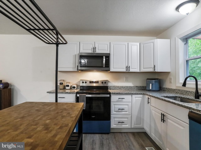 74 Red Maple Ln, Harpers Ferry, WV 25425 - kitchen with a sink, butcher block counters, white cabinets, and appliances with stainless steel finishes