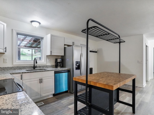 74 Red Maple Ln, Harpers Ferry, WV 25425 - kitchen featuring stainless steel fridge, a sink, white cabinetry, dishwasher, and light wood-style floors