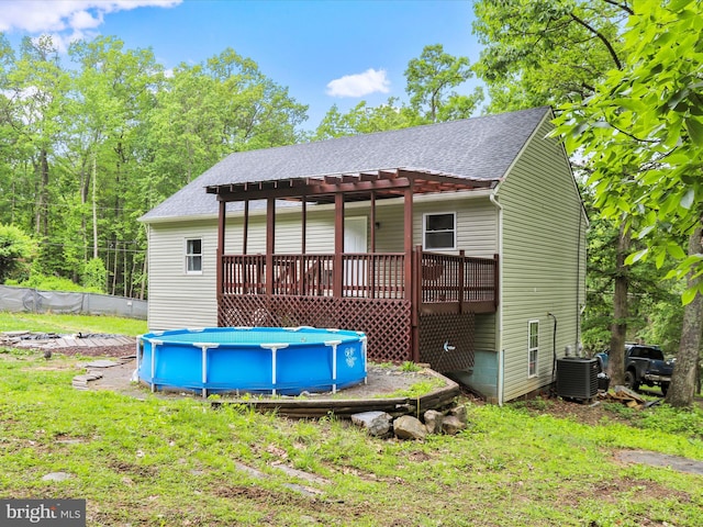 74 Red Maple Ln, Harpers Ferry, WV 25425 - back of house featuring a pergola, a wooden deck, a shingled roof, central AC unit, and an outdoor pool