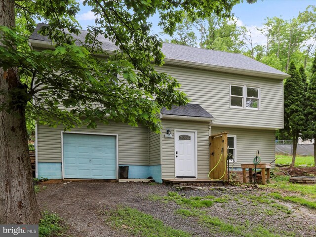 74 Red Maple Ln, Harpers Ferry, WV 25425 - view of front of home with a garage, dirt driveway, and a shingled roof