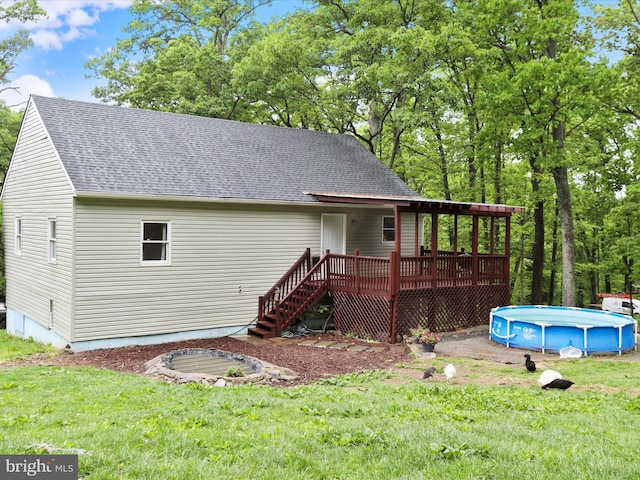74 Red Maple Ln, Harpers Ferry, WV 25425 - rear view of property with a yard, an outdoor pool, a shingled roof, stairway, and a wooden deck