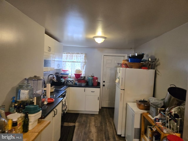933 Bennett Pl, Baltimore, MD 21223 - kitchen featuring dark wood-style flooring, freestanding refrigerator, a sink, and white cabinetry
