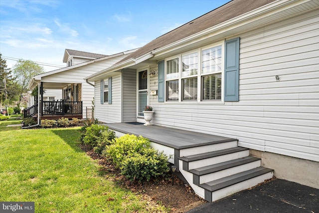 rear view of property with a yard and a porch