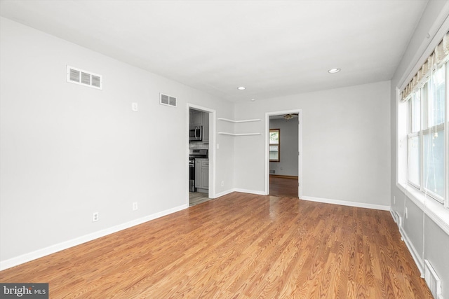 empty room featuring a wealth of natural light and visible vents