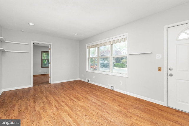 entryway with a healthy amount of sunlight, light wood-style floors, and visible vents