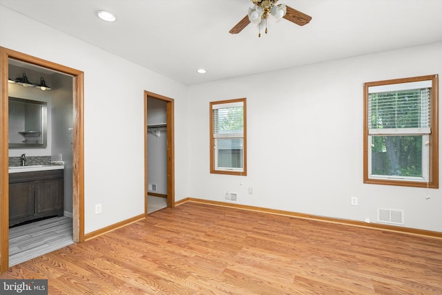 unfurnished bedroom featuring baseboards, visible vents, and light wood-type flooring