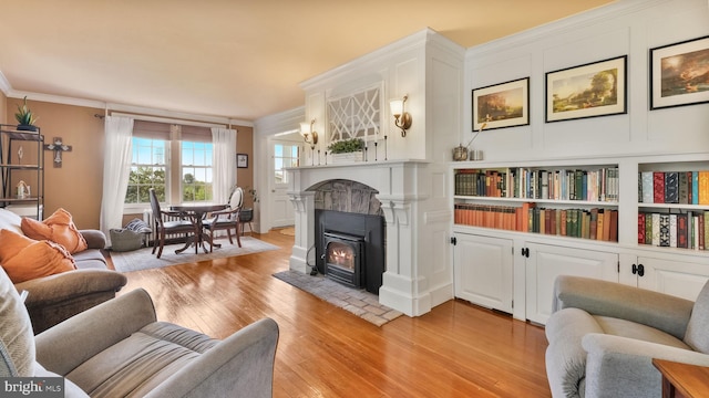 477 Linton Hill Rd, Newtown, PA 18940 - living area with light wood-type flooring, crown molding, and a warm lit fireplace