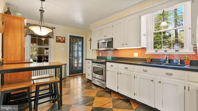 477 Linton Hill Rd, Newtown, PA 18940 - kitchen with a sink, white cabinetry, appliances with stainless steel finishes, and dark countertops
