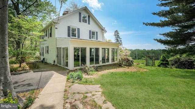 477 Linton Hill Rd, Newtown, PA 18940 - back of house featuring a sunroom, a yard, and a chimney