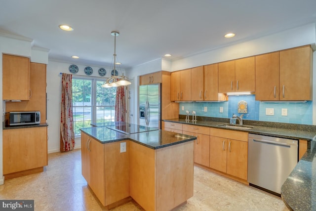 3201 Blue Heron Dr Unit 01, Rehoboth Beach, DE 19971 - kitchen with appliances with stainless steel finishes, a sink, dark stone countertops, a center island, and backsplash
