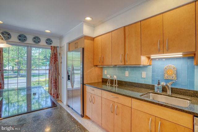 3201 Blue Heron Dr Unit 01, Rehoboth Beach, DE 19971 - kitchen featuring stainless steel fridge with ice dispenser, a sink, ornamental molding, dark stone countertops, and backsplash