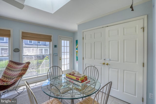 3201 Blue Heron Dr Unit 01, Rehoboth Beach, DE 19971 - dining area featuring crown molding, a skylight, and light tile patterned flooring