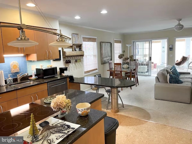 3201 Blue Heron Dr Unit 01, Rehoboth Beach, DE 19971 - kitchen with a sink, dishwashing machine, black microwave, recessed lighting, and tasteful backsplash