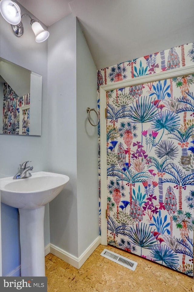 3201 Blue Heron Dr Unit 01, Rehoboth Beach, DE 19971 - bathroom with baseboards, vaulted ceiling, and a sink