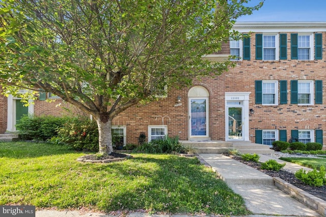 12104 Stallion Ct, Woodbridge, VA 22192 - view of front facade with brick siding and a front lawn