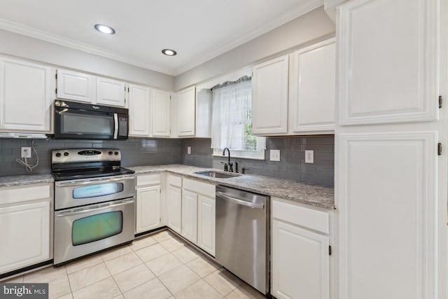 kitchen with a sink, light tile patterned flooring, ornamental molding, stainless steel appliances, and white cabinetry
