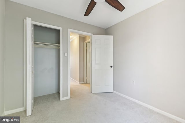 unfurnished bedroom featuring a closet, baseboards, and light carpet