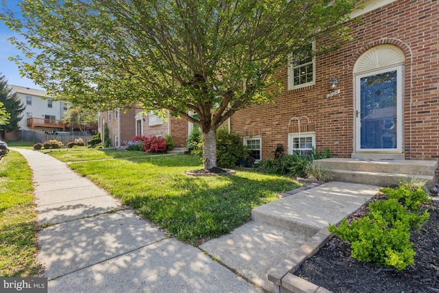 12104 Stallion Ct, Woodbridge, VA 22192 - exterior space with brick siding, fence, and a front yard