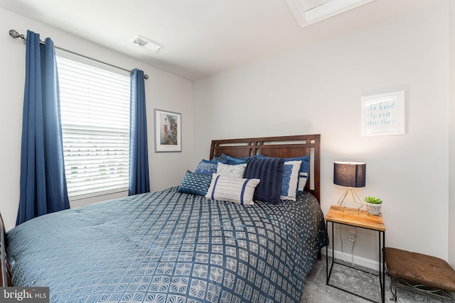 carpeted bedroom featuring baseboards