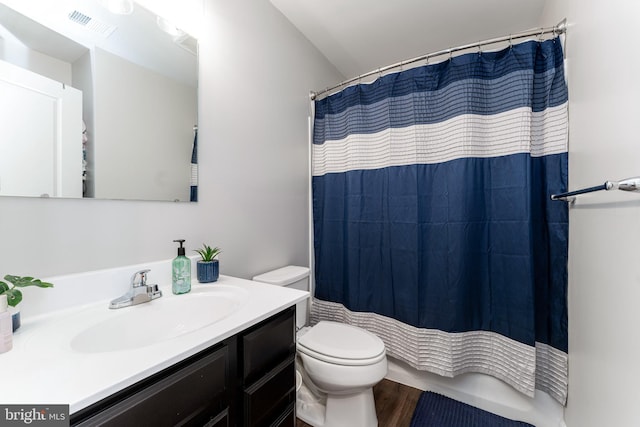 full bathroom featuring toilet, vanity, and wood finished floors