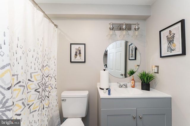 bathroom with toilet, vanity, and a shower with curtain